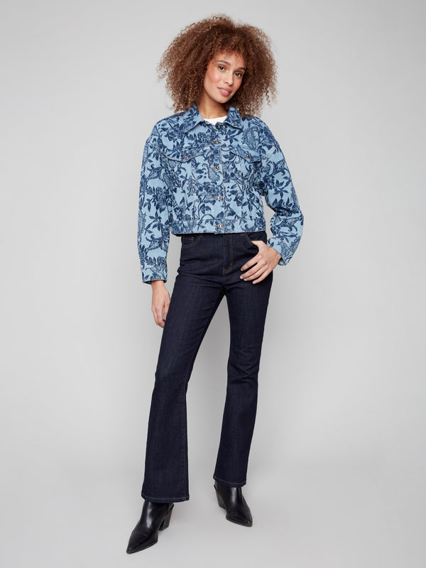 Chic cropped denim jacket with two convenient chest flap pockets and a beautiful floral design for added flair by Charlie B.