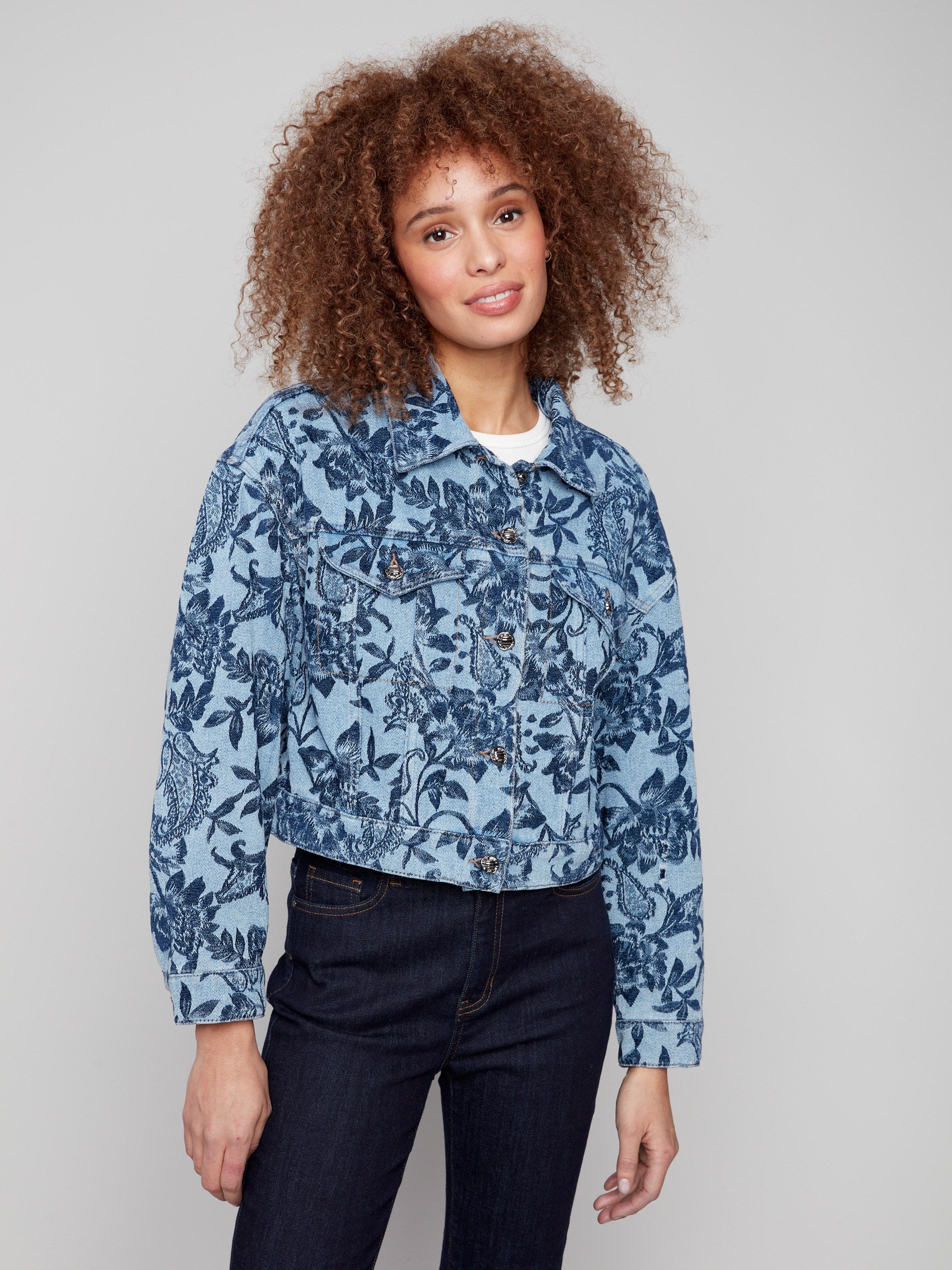 Elegant blue cropped jacket showcasing a stunning floral jacquard design, ideal for layering over any outfit by Charlie B.
