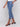 Blue jeans featuring an asymmetrical hem and stretch denim material by Charlie B.
