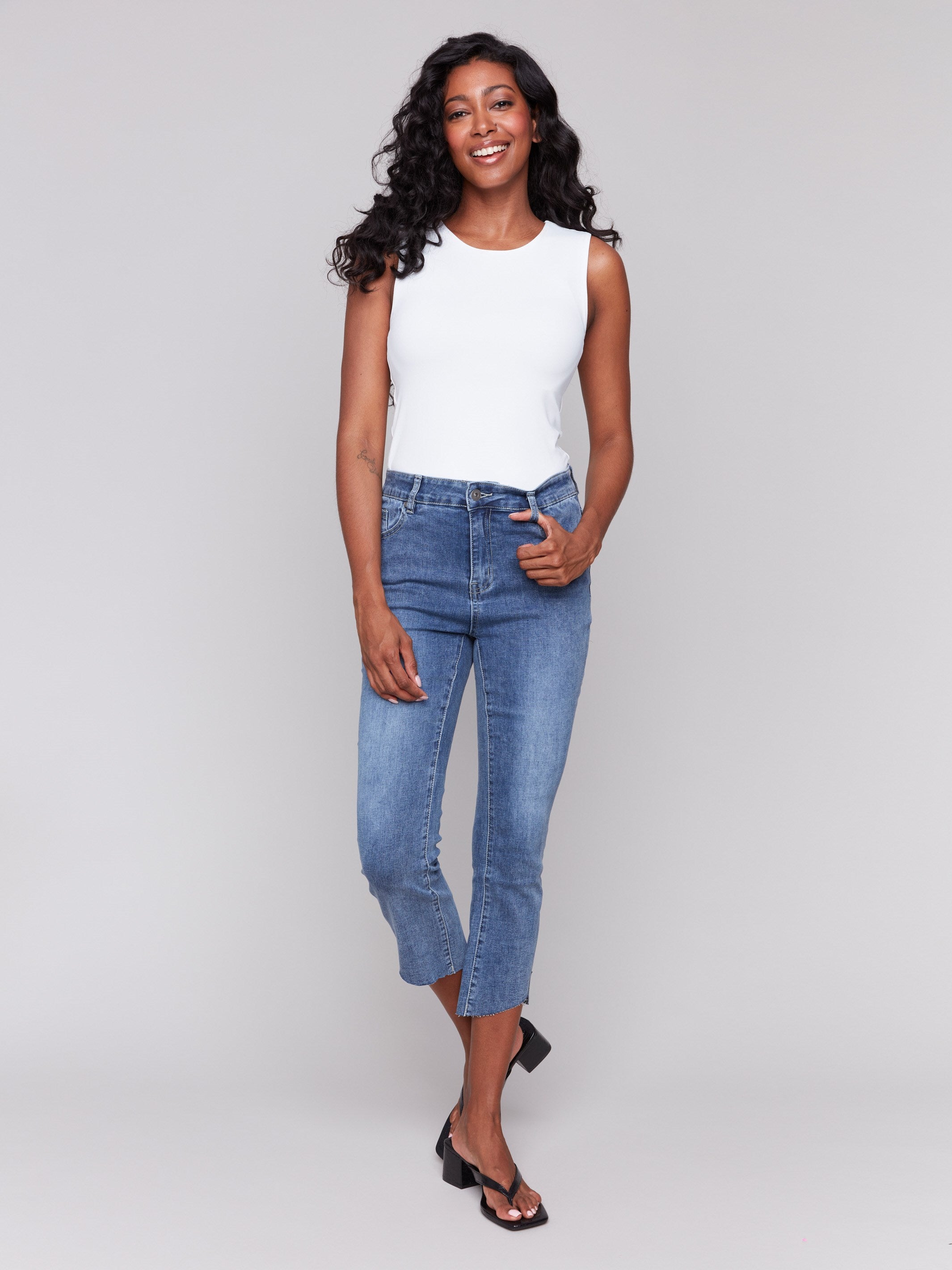 Classic five-pocket design in medium blue cropped jeans by Charlie B.