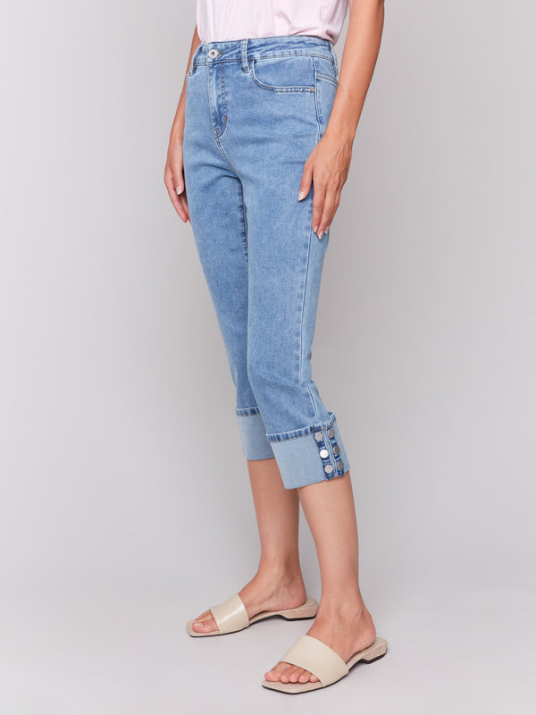 Light blue jeans with snap button detail at hem by Charlie B.