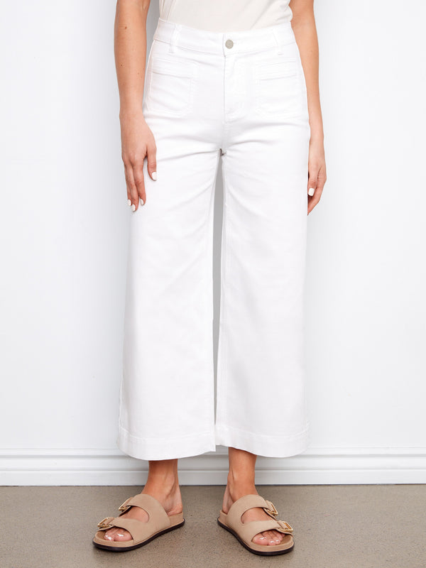 White cropped flare twill pants showcasing front patch pockets and comfortable back pockets by Charlie B.