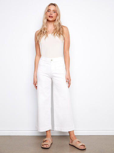 White cropped flare twill pants offering a chic look with their regular rise and stylish design by Charlie B.