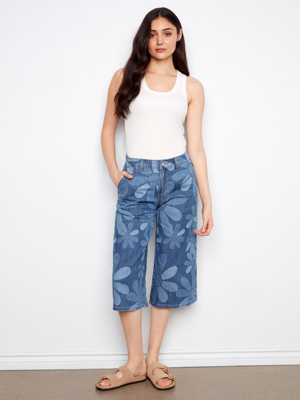 Denim palazzo jeans with a floral pattern, featuring slash pockets for a touch of practicality by Charlie B.
