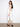 White cropped jeans featuring a five-pocket design and snap button cuffs, offering a stylish narrow leg look by Charlie B.