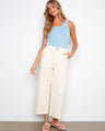Natural twill pants featuring a straight fit and styled with a light blue top and sandals. Made for comfort by Charlie B.