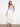 Natural twill pants featuring a straight fit and styled with a light blue top and sandals. Made for comfort by Charlie B.