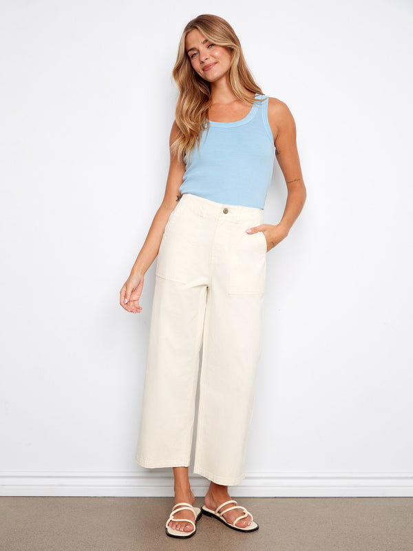 Natural twill pants featuring a straight fit and styled with a light blue top and sandals. Made for comfort by Charlie B.