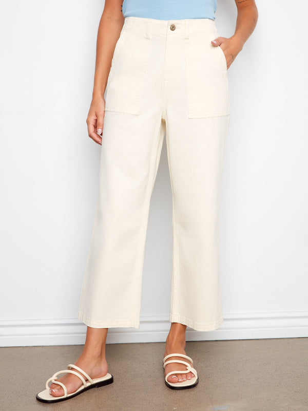 Showcasing cropped length twill pants paired with a light blue top, perfect for casual outings. Designed by Charlie B.