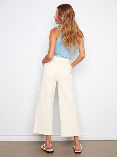 Stretch twill fabric ensures comfort in these stylish cropped pants, complemented by a light blue top. Fashioned by Charlie B.