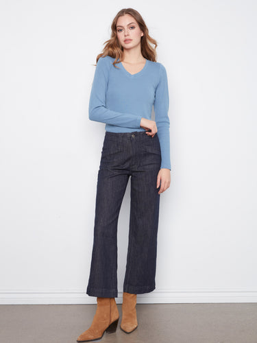 Denim pants with unique rectangular patch pockets, adding functionality and style. By Charlie B.