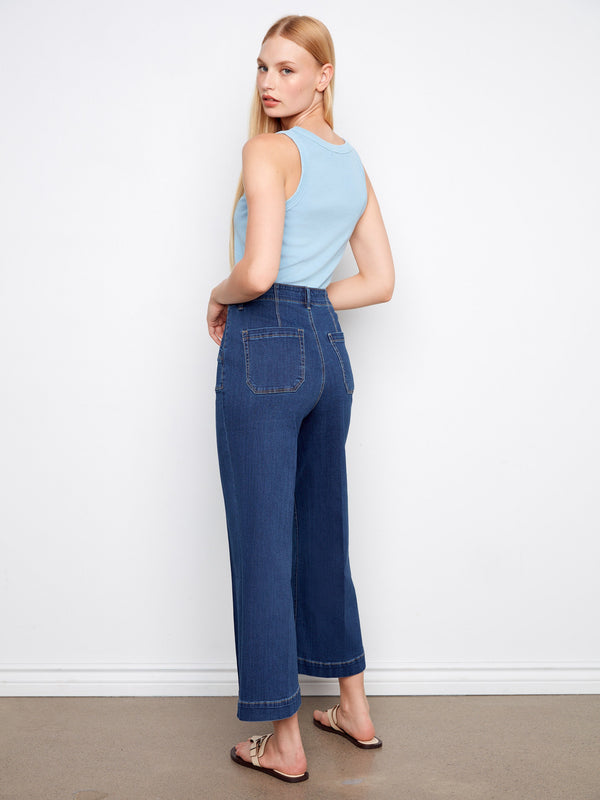 Jeans with rectangular patch pockets adding a touch of utility to the design by Charlie B.