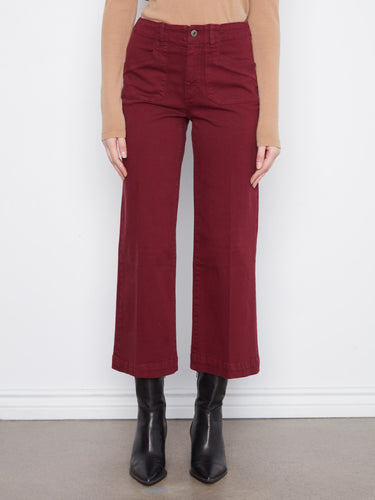 These cropped length pants in burgundy feature rectangular patch pockets, adding a practical touch to the chic design by Charlie B.