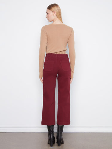 The burgundy pants showcase rectangular patch pockets and a flattering wide leg silhouette for modern elegance by Charlie B.