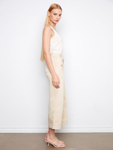 Elegant beige pants with practical slash pockets and a fashionable cropped length, perfect for versatile styling options by Charlie B.