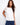 Elegant white top with a crew neckline, featuring beautiful embroidery on the shoulder for a stylish touch. Crafted by Charlie B.