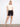 Chic black shorts include a woven belt, complementing the light top and sandals for an effortless look by Charlie B.