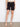Shorts in classic black design are enhanced with cuffed hems and matched with strappy sandals for a modern vibe by Charlie B.