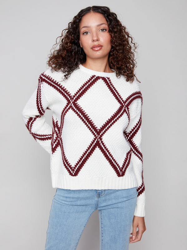 White sweater showcasing a cabernet diamond pattern and crew neck, with a stylish drop shoulder design by Charlie B.