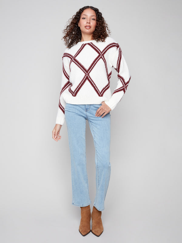 Chic white sweater adorned with a cabernet diamond motif, offering comfort and style through its drop shoulder design by Charlie B.