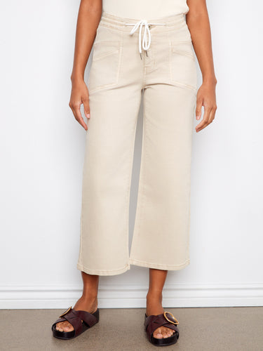 These beige pants offer a regular rise fit with patch pockets, combining comfort and style effortlessly by Charlie B.