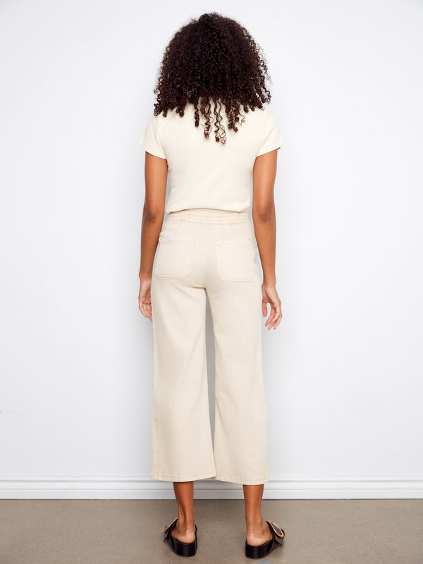 Stylish beige wide leg pants designed with functional patch pockets, adding practicality to your wardrobe by Charlie B.