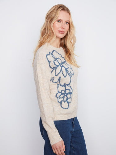 This sweater features drop shoulders that enhance its relaxed fit. The floral design adds a touch of elegance by Charlie B.