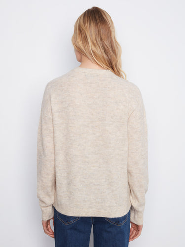 The back view highlights the smooth knit fabric of this stylish sweater, offering both comfort and fashion in one piece by Charlie B.