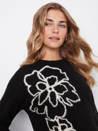 Stylish black sweater highlighted by a striking floral motif, complete with ribbed cuffs and hem by Charlie B.