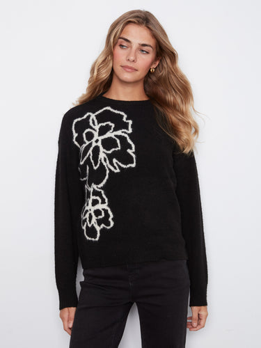 Chic black sweater featuring an eye-catching floral pattern, designed with cozy ribbed cuffs by Charlie B.