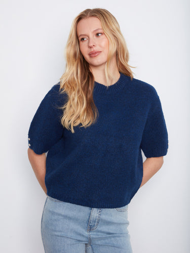 Designed with elbow-length sleeves, this blue knit top is perfect for transitional weather and easy layering. By Charlie B.