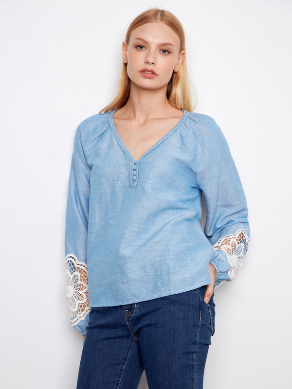 Elegant balloon sleeves on a light blue blouse, offering a relaxed yet fashionable vibe. By Charlie B.