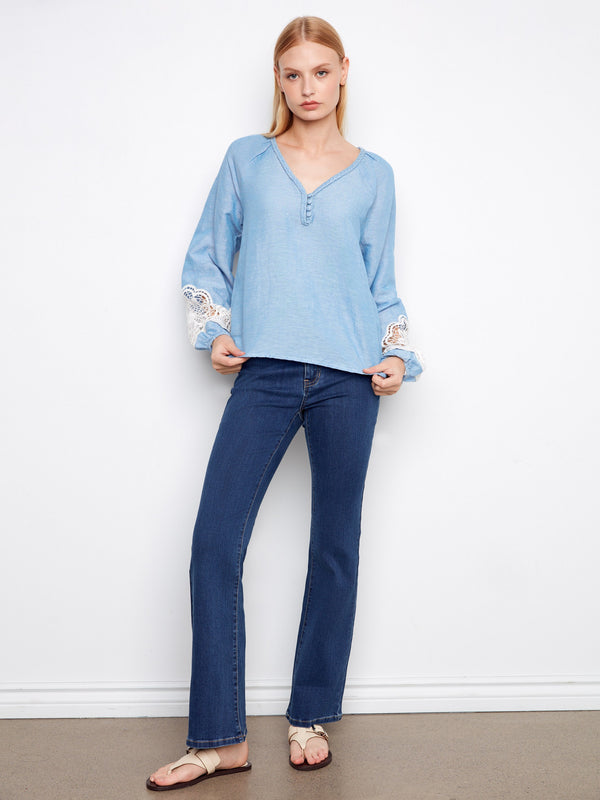 Casual and chic blue blouse perfect for any occasion, paired seamlessly with jeans. By Charlie B.