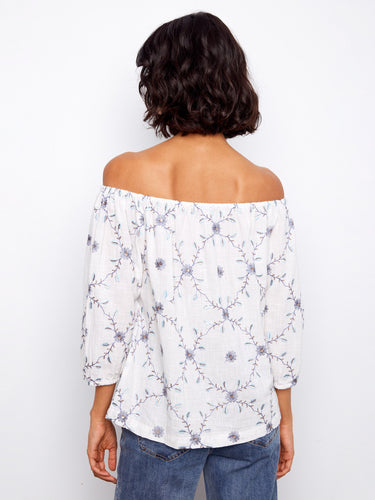 Floral embroidered blouse in crisp white, designed with an off-the-shoulder fit and soft 3/4 sleeves, made from cotton by Charlie B.