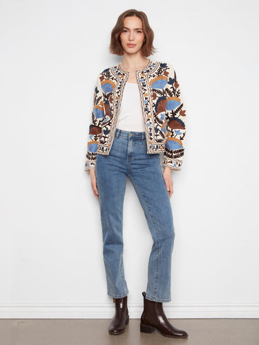 Elegant basketweave texture enhances the black collarless jacket with floral embroidery by Charlie B.