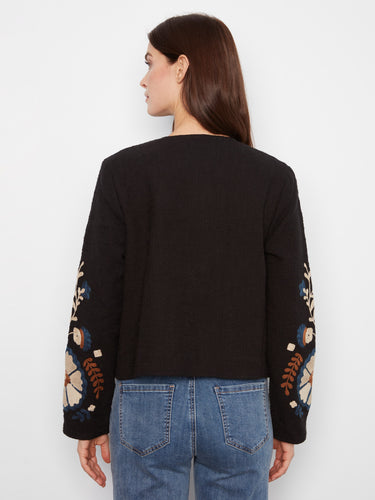 This exquisite piece features an embroidered design on a luxurious basketweave texture, ideal for stylish layering. By Charlie B.