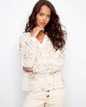 Ecru blouse with a braided collar detail, showcasing intricate floral embroidery and long sleeves, made from 100% cotton by Charlie B.