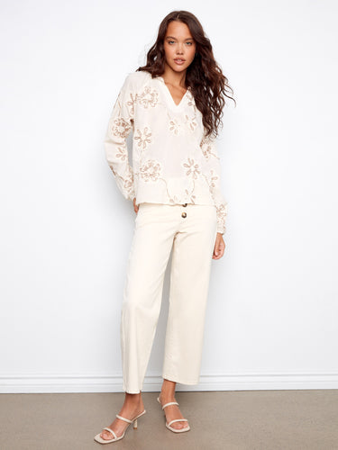 Elegant popover blouse in ecru featuring a notched neckline and delicate floral embroidery on raglan sleeves by Charlie B.