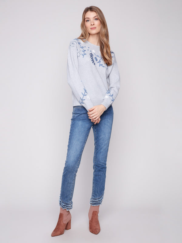 Chic embroidered floral pattern elevates this heather grey drop shoulder sweater by Charlie B.