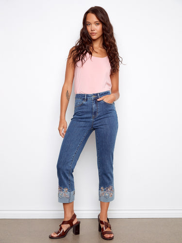 Medium blue jeans with stretch denim for comfort, highlighted by intricate embroidery at the cuffs by Charlie B.