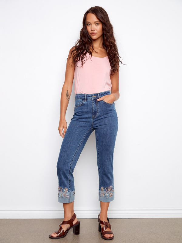 Medium blue jeans with stretch denim for comfort, highlighted by intricate embroidery at the cuffs by Charlie B.