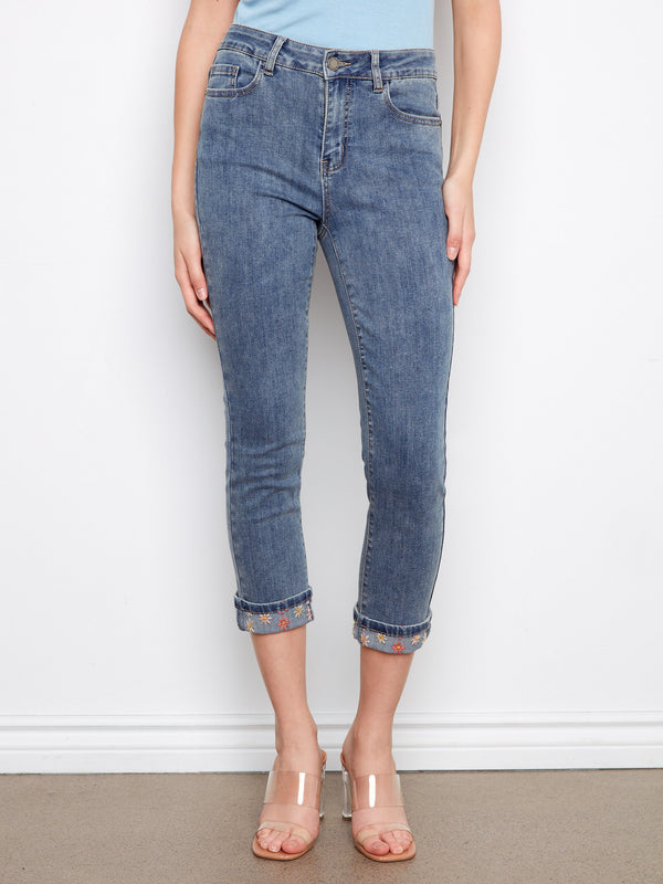 Cropped length medium blue jeans featuring a regular rise and stylish embroidery at the cuffs by Charlie B.