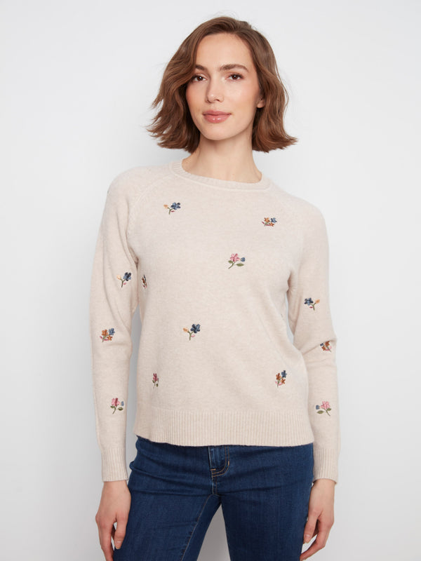 The sweater features a classic crew neck, offering a timeless and versatile look for any wardrobe. By Charlie B.