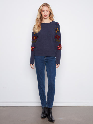 This stylish sweater boasts long raglan sleeves, providing comfort and flexibility for everyday wear. By Charlie B.