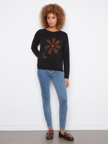 Elegant black sweater featuring a charming floral design and long sleeves by Charlie B.