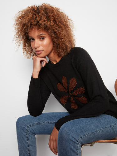 Chic black sweater adorned with beautiful embroidered flowers, offering comfort and style by Charlie B.