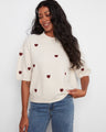 This knit sweater features a charming mock neck design, adding a touch of sophistication to your casual wardrobe. By Charlie B.