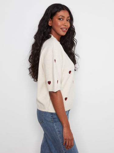 With its elegant design and thoughtful details, this versatile sweater is an essential addition to any wardrobe. By Charlie B.