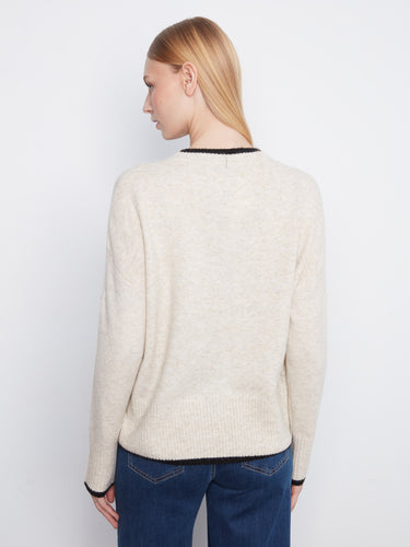 The soft texture of this sweater complements its elegant design, creating a chic look that's both comfortable and fashionable. By Charlie B.