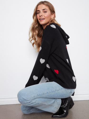 Fashionable knit sweater adorned with embroidered hearts, complete with a functional hood for extra style. By Charlie B.
